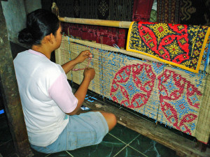 Wrapping thread with plastic tape, prior to dying,Teganan, Bali 